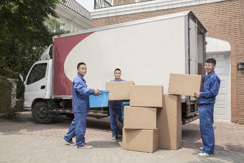 Man with van loading furniture into a moving vehicle