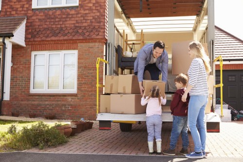 Packed moving boxes and furniture ready for transport in Hampton