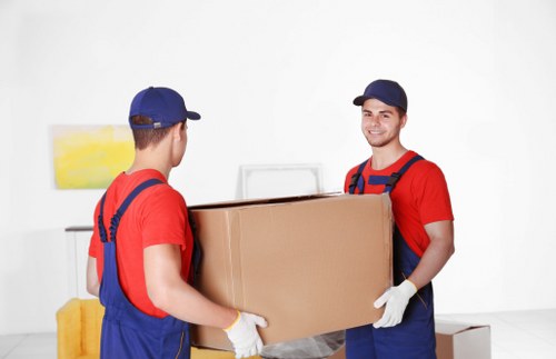 Boxes, desks, and office items organized for commercial removals in Hampton