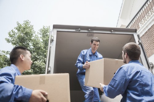 Packed boxes and furniture ready for a man with van move in Hampton