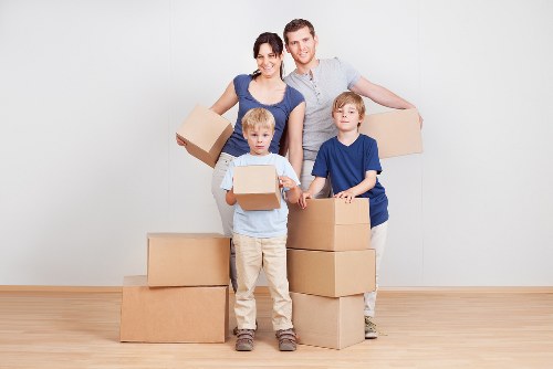 Packed moving boxes and furniture ready for house removals in Hampton