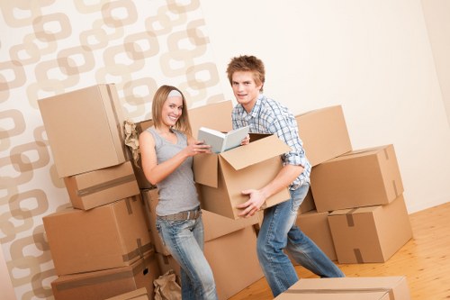 Mover wearing PPE while loading items for a safe removal service